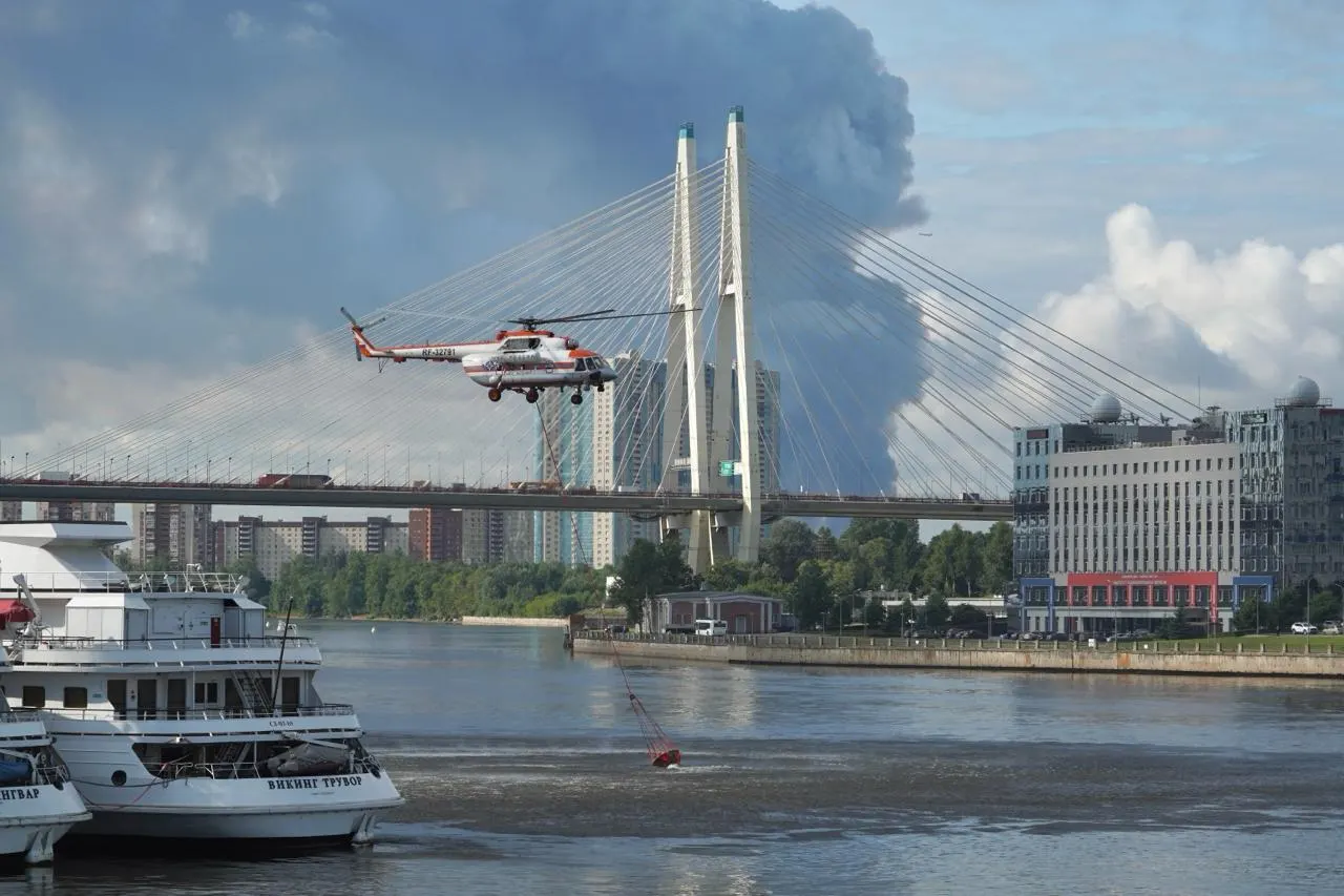 При тушении пожара в Санкт-Петербурге часть воды для пожарных вертолётов берут прямо из Невы — на кадрах видно процесс забора и вылеты техники.